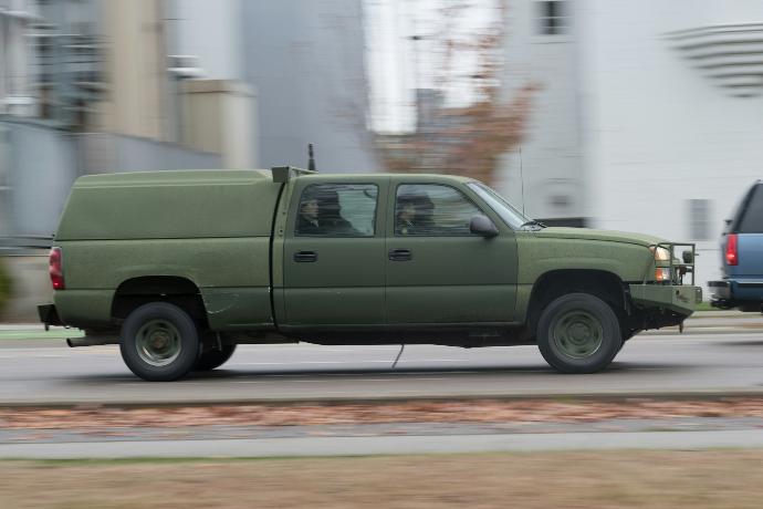 a green pickup truck on a road